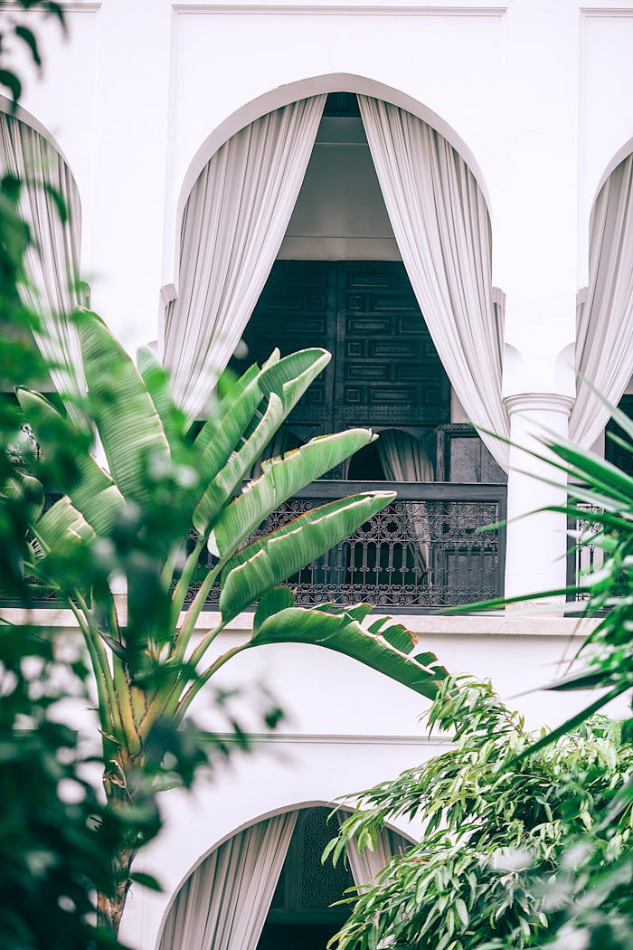 White arched balcony with metal railings